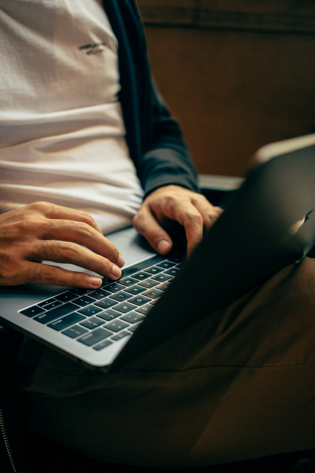 author typing on laptop